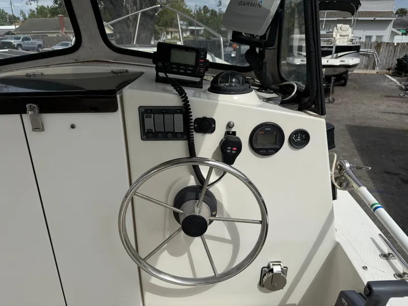 Slide: The Image of 2015 Atlas Boat Works Pompano 23 helm with steering wheel and navigation instruments. - 18