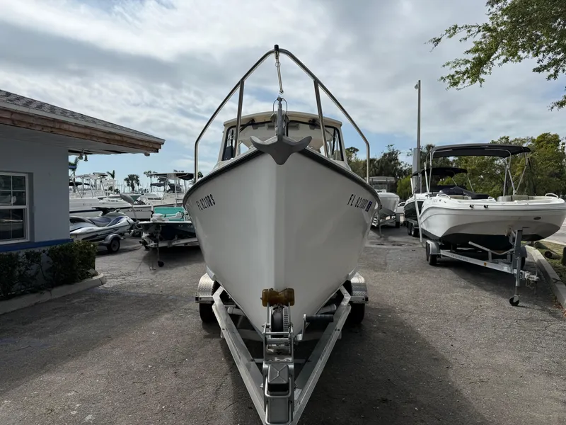 Slide: The Image of 2015 Atlas Boat Works Pompano 23 on trailer, parked outdoors. - 2