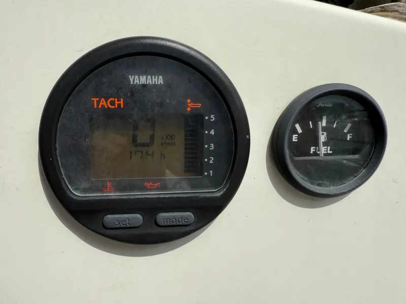 Slide: The Image of Yamaha tachometer and fuel gauge on 2015 Atlas Boat Works Pompano 23 dashboard. - 21