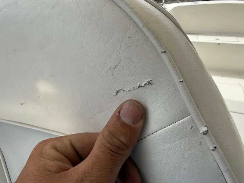 Slide: The Image of Close-up of damaged white upholstery on a 2015 Atlas Boat Works Pompano 23. - 22