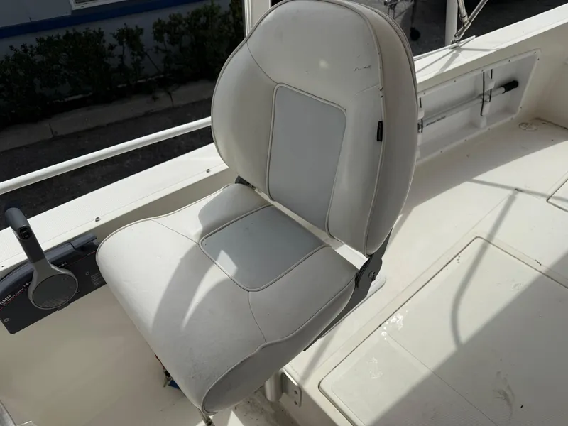 Slide: The Image of Captain's chair on 2015 Atlas Boat Works Pompano 23, white upholstery. - 23