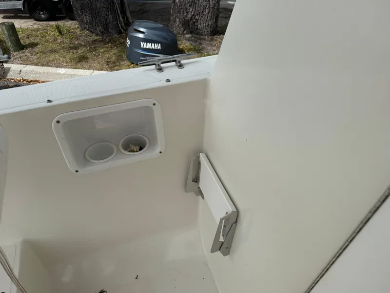 Slide: The Image of 2015 Atlas Boat Works Pompano 23 interior with Yamaha engine visible. - 25