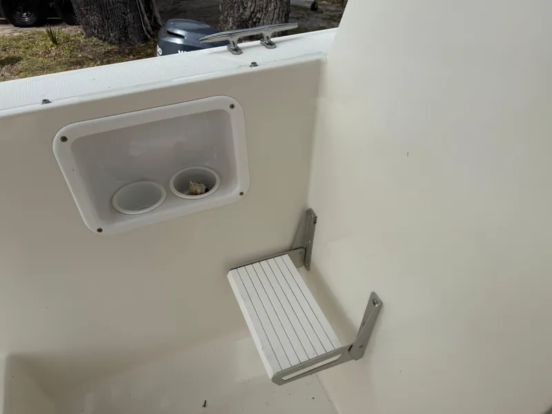Slide: The Image of Interior of 2015 Atlas Boat Works Pompano 23, featuring a foldable seat and storage compartment. - 26