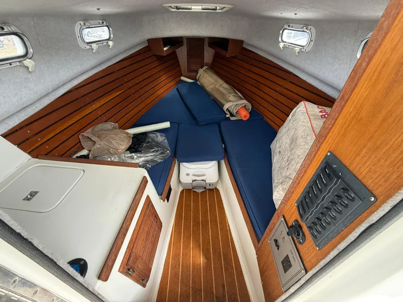 Slide: The Image of 2015 Atlas Boat Works Pompano 23 cabin interior with wooden accents and blue cushions. - 28