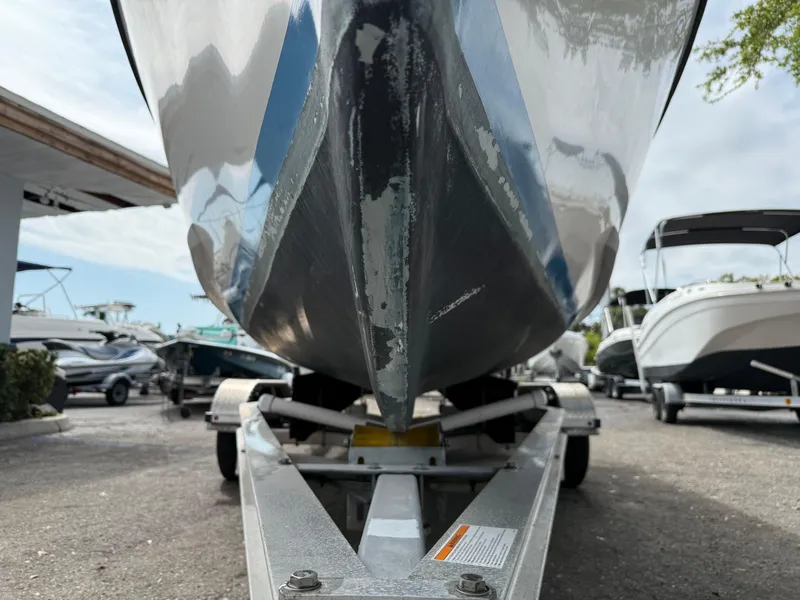 Slide: The Image of 2015 Atlas Boat Works Pompano 23 on trailer, parked in a marina. - 3
