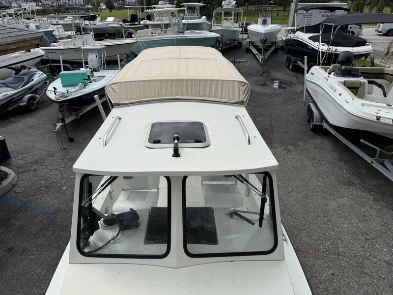 Slide: The Image of 2015 Atlas Boat Works Pompano 23 docked among other boats. - 34