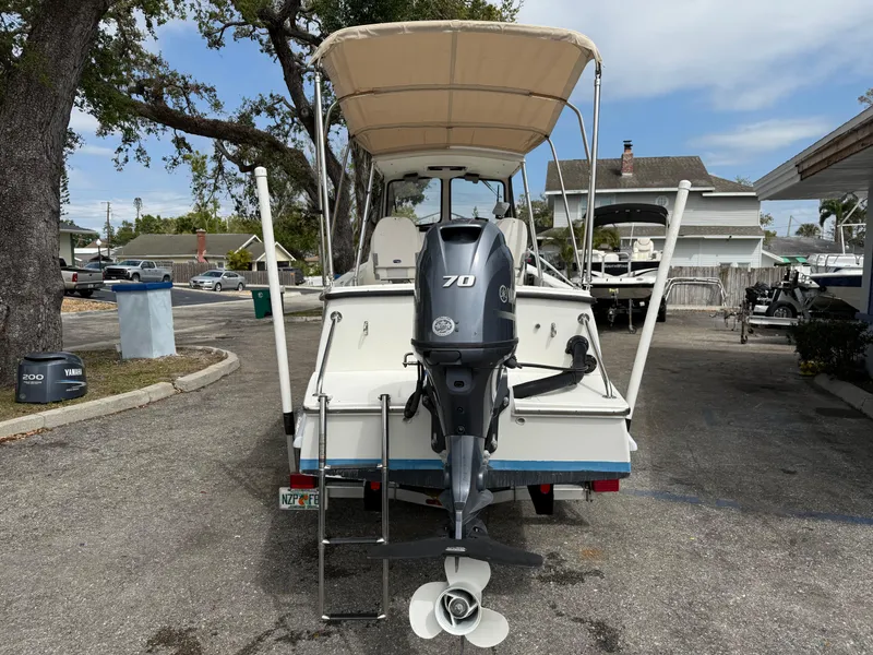 Slide: The Image of 2015 Atlas Boat Works Pompano 23 with Yamaha 70 outboard motor, parked outdoors. - 5