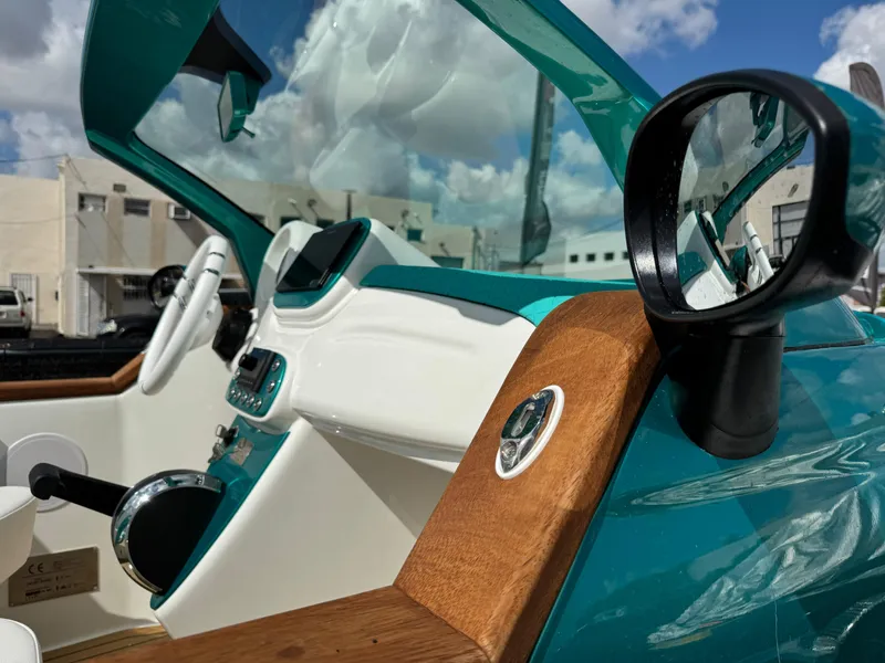 Slide: The Image of Interior of 2025 Car Off-shore Fiat 500 Classic, featuring teal and white design elements. - 25