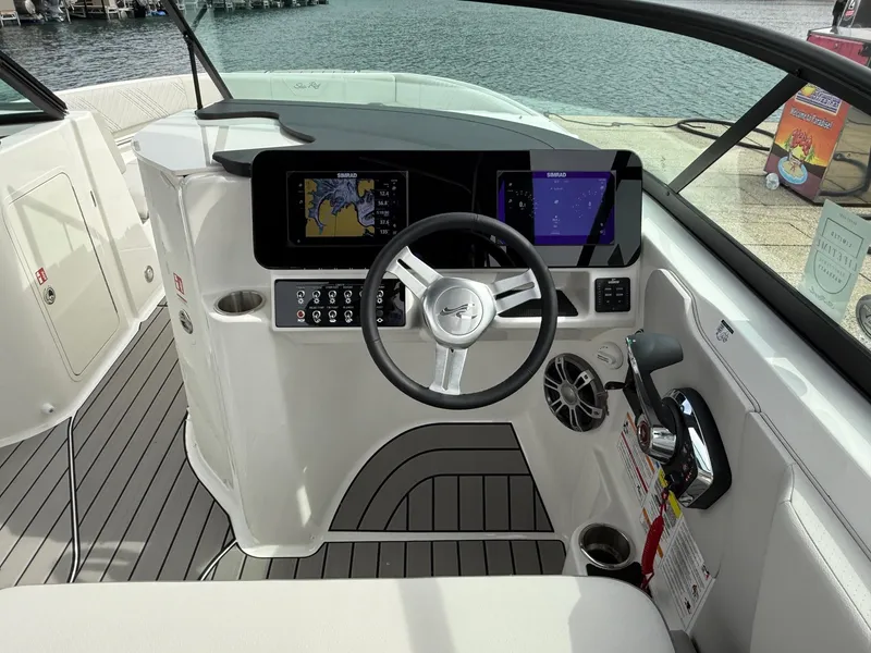 Slide: The Image of 2025 Sea Ray SDX 250 boat cockpit with modern steering and digital displays. - 7