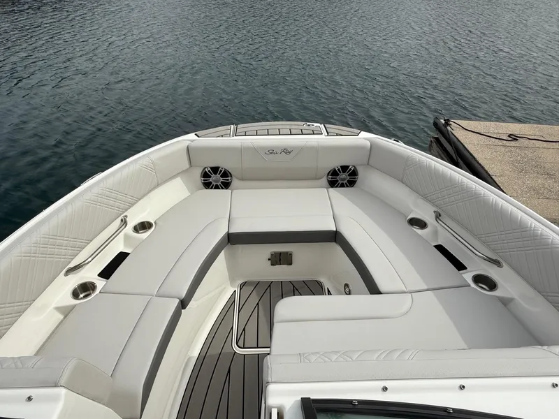 Slide: The Image of 2025 Sea Ray SDX 250 boat interior with white seating and cup holders. - 8