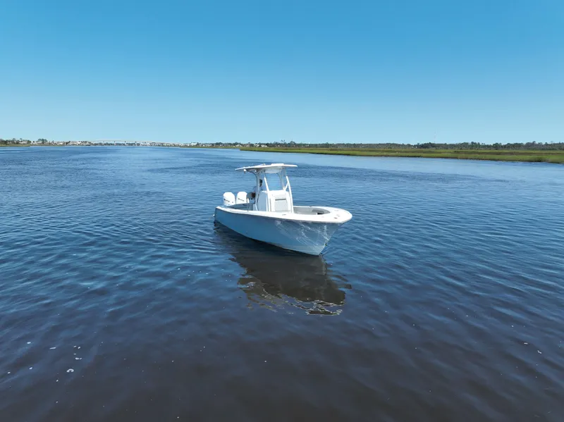 Slide: The Image of 2023 Front Runner 26 Center Console boat on calm water under clear blue sky. - 10