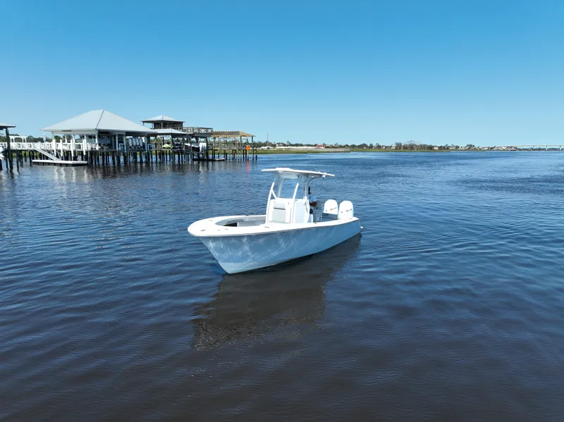 Slide: The Image of 2023 Front Runner 26 Center Console boat on calm water near a dock. - 12