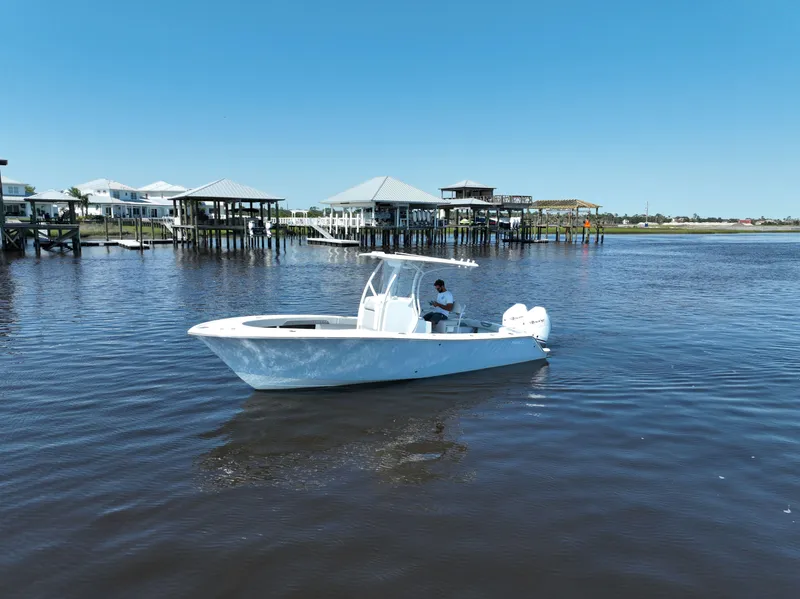 Slide: The Image of 2023 Front Runner 26 Center Console boat on calm water near docks. - 13