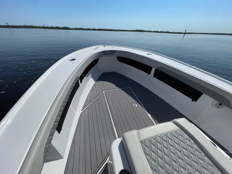 Slide: The Image of 2023 Front Runner 26 Center Console boat on calm water, featuring sleek deck design. - 15