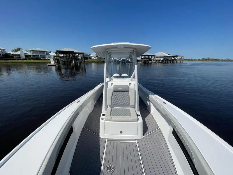 Slide: The Image of 2023 Front Runner 26 Center Console boat on calm water, clear sky background. - 16