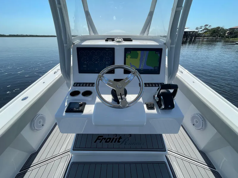 Slide: The Image of 2023 Front Runner 26 Center Console boat dashboard with dual screens and steering wheel. - 20