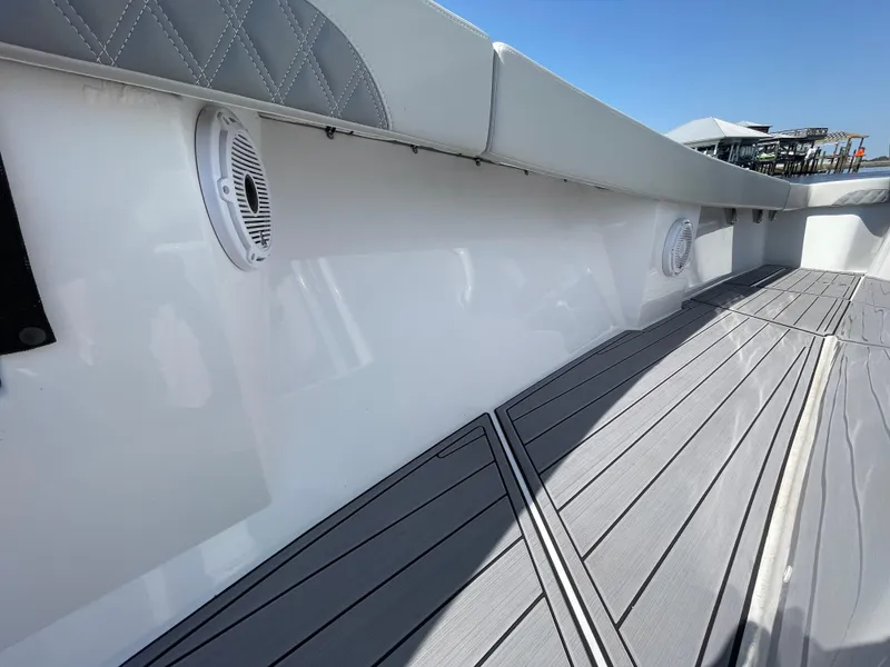 Slide: The Image of 2023 Front Runner 26 Center Console boat interior with speakers and cushioned seating. - 25