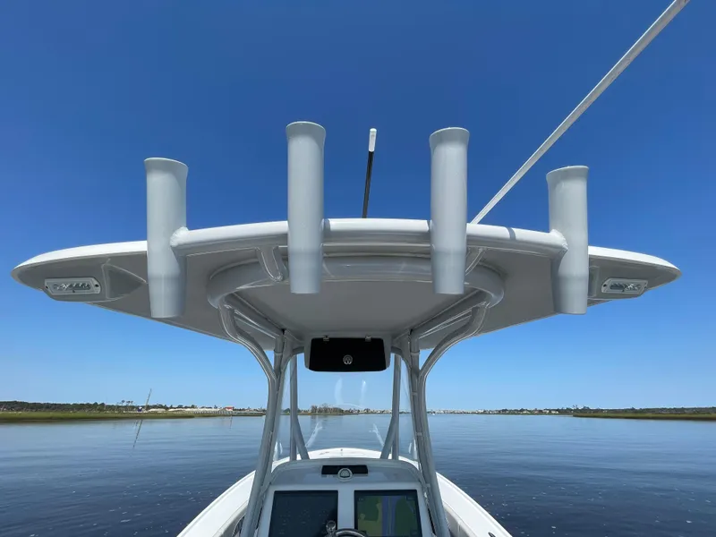Slide: The Image of 2023 Front Runner 26 Center Console boat on calm water under clear blue sky. - 27