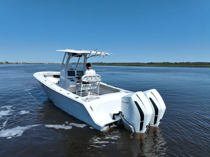Slide: The Image of 2023 Front Runner 26 Center Console boat on calm water, featuring dual engines. - 3