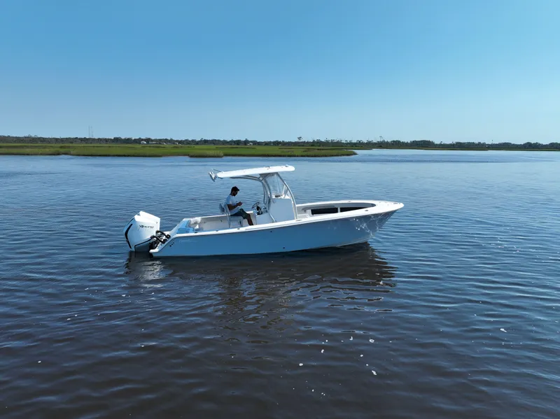 Slide: The Image of 2023 Front Runner 26 Center Console boat on calm water under clear blue sky. - 7