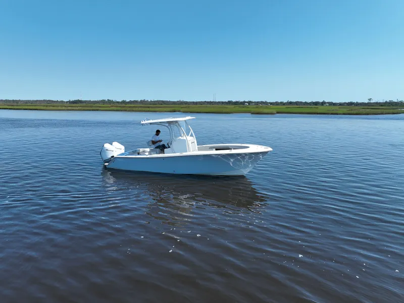 Slide: The Image of 2023 Front Runner 26 Center Console boat on calm water under clear blue sky. - 8