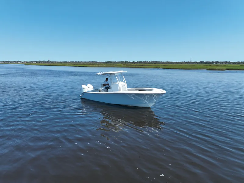 Slide: The Image of 2023 Front Runner 26 Center Console boat on calm water under clear blue sky. - 9