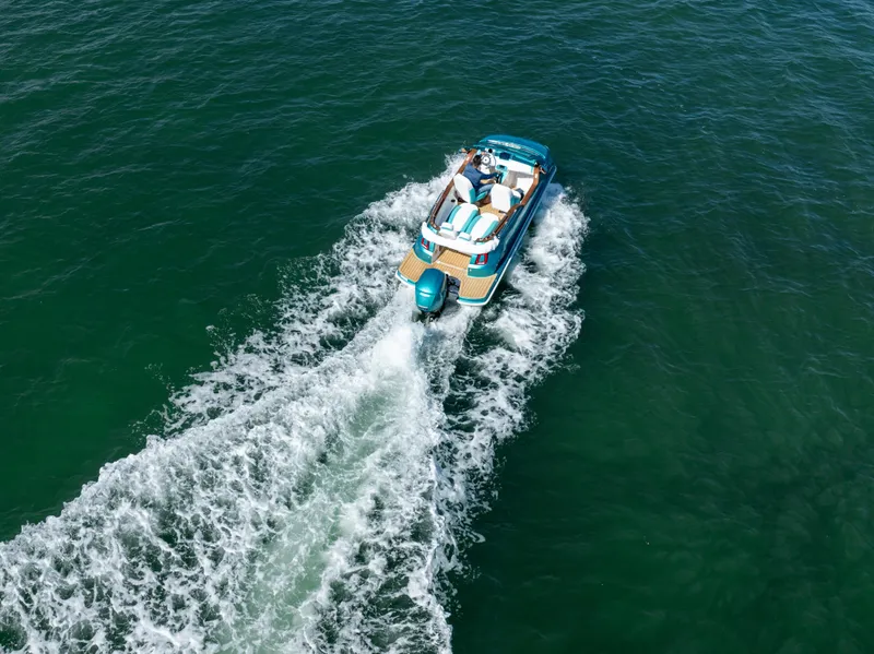 Slide: The Image of Aerial view of a Car Off-shore Fiat 500 Classic boat cruising on open water, 2025 model. - 13