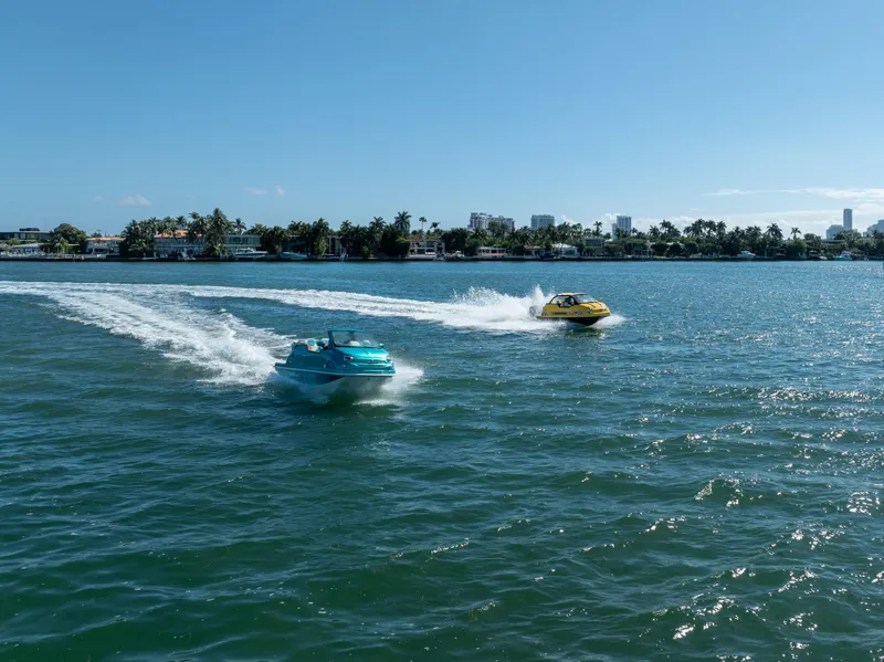 Slide: The Image of Two Fiat 500 Classic boats racing on a sunny day, 2025 model. - 15