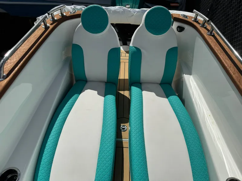 Slide: The Image of 2025 Car Off-shore Fiat 500 Classic interior with teal and white seats. - 21
