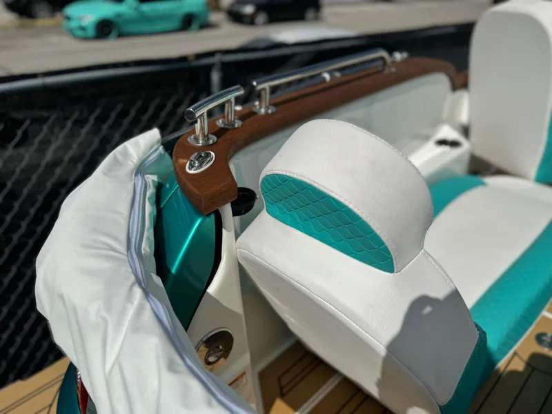 Slide: The Image of Interior of a 2025 Car Off-shore Fiat 500 Classic with teal and white seats. - 22