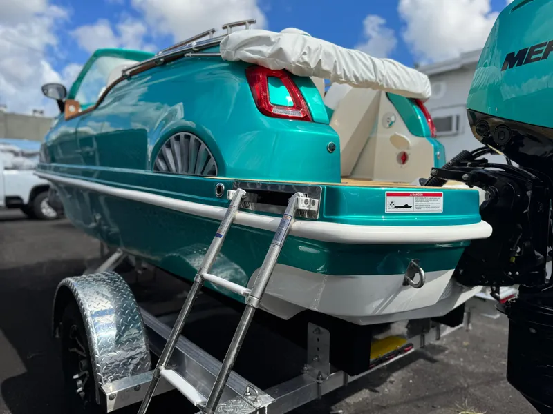 Slide: The Image of Turquoise Fiat 500 Classic boat hybrid on trailer, showcasing unique design and vibrant color. - 24