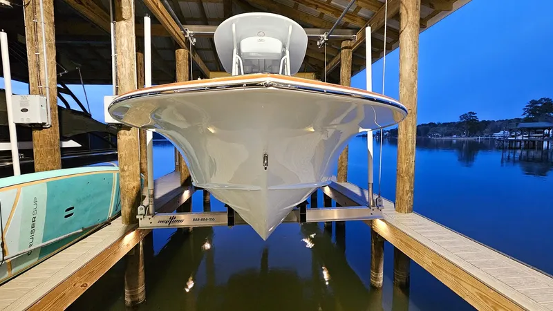 Slide: The Image of 2025 Chaos 21 Tarpon Bay boat docked in serene waters at sunset. - 5