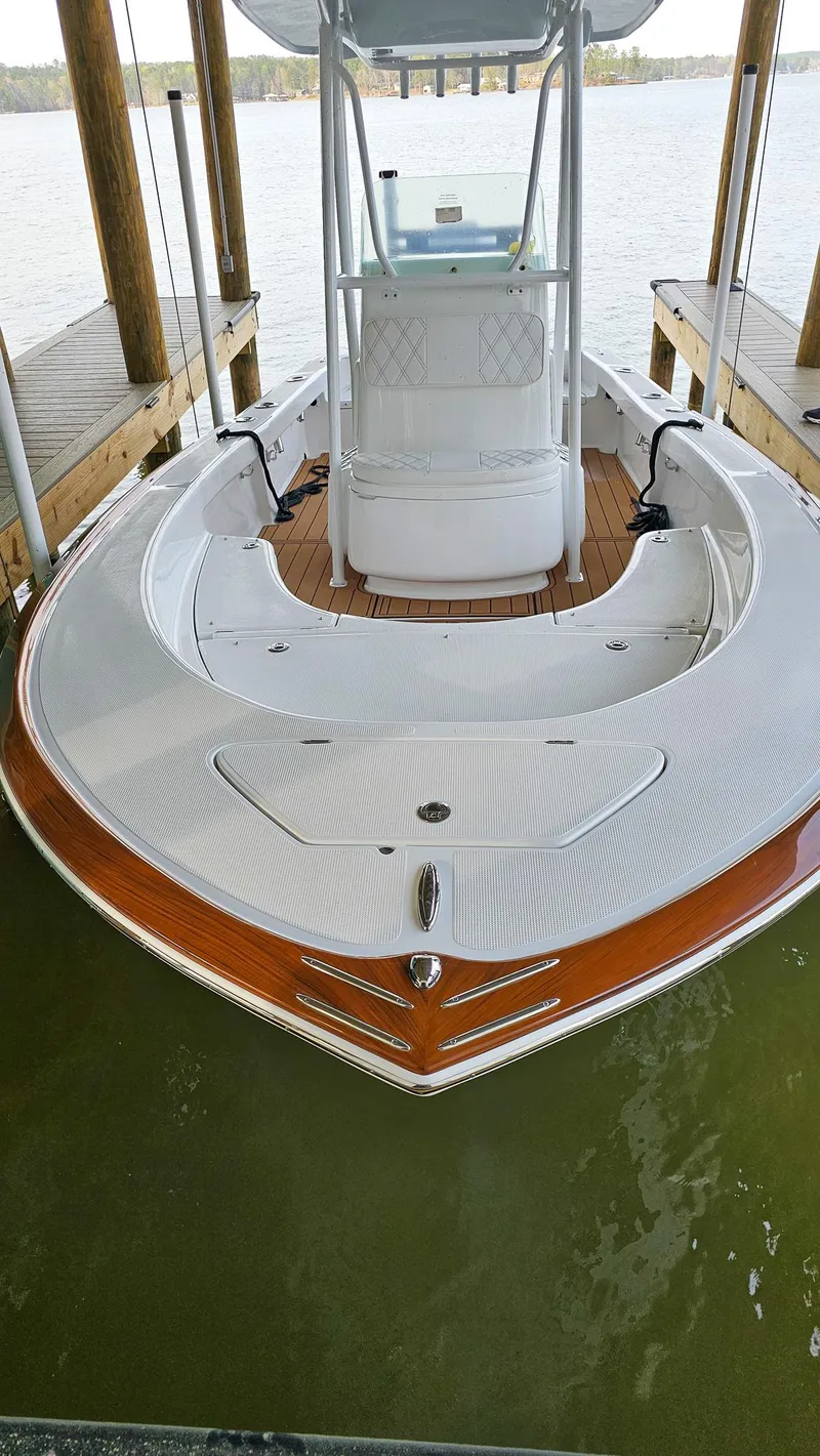 Slide: The Image of 2025 Chaos 21 Tarpon Bay boat docked, showcasing sleek design and spacious deck. - 8