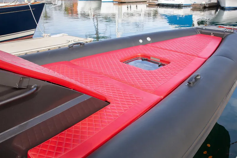 Slide: The Image of 2023 Novielli Veloche 349 boat with red quilted deck at marina. - 11