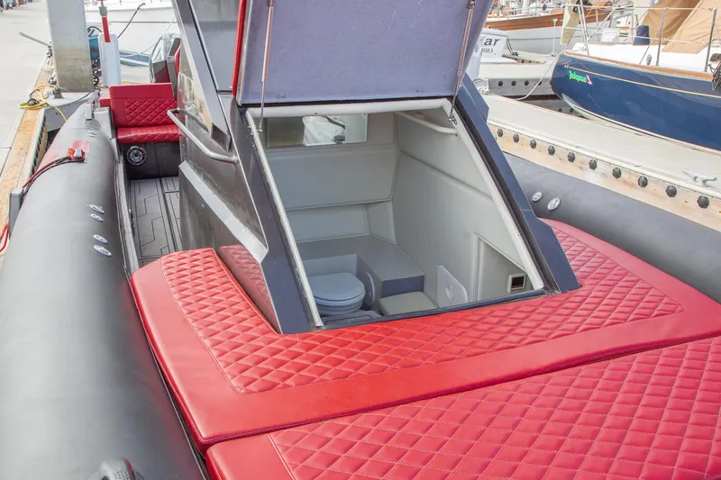 Slide: The Image of 2023 Novielli Veloche 349 boat with red quilted seating and open cabin hatch. - 12