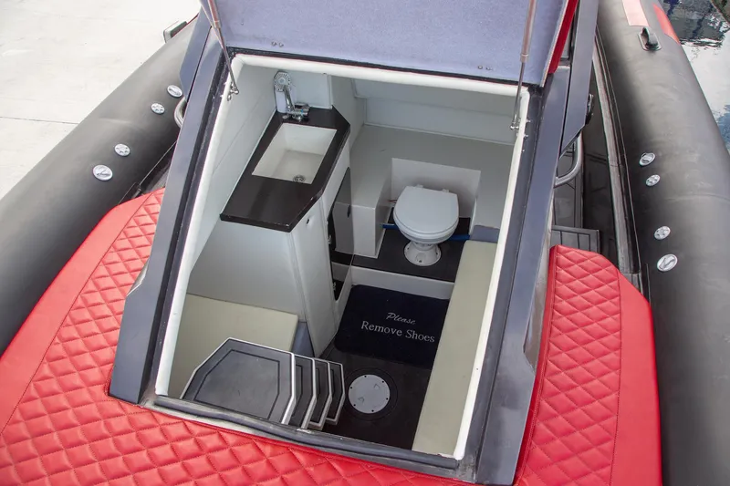Slide: The Image of 2023 Novielli Veloche 349 boat interior with sink, toilet, and red quilted seating. - 13
