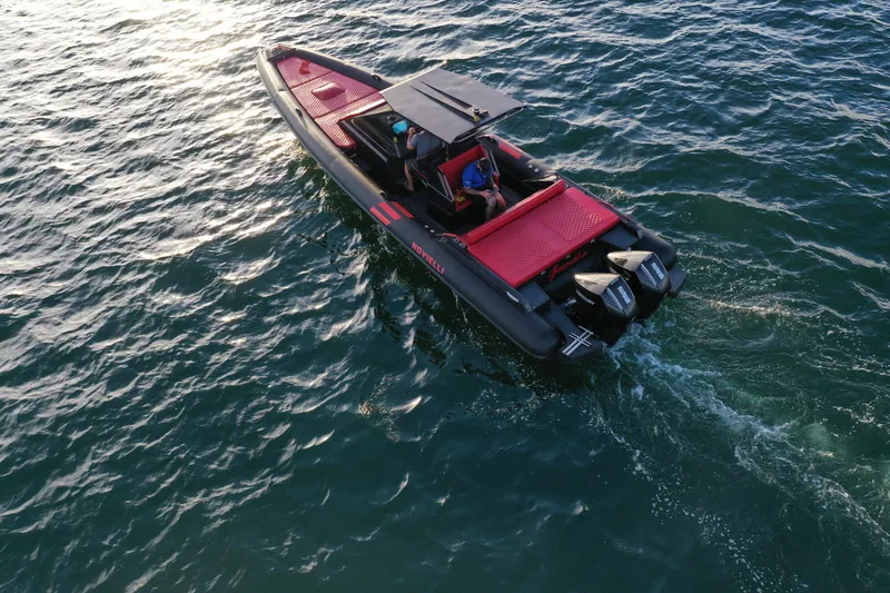 Slide: The Image of 2023 Novielli Veloche 349 boat cruising on open water, featuring sleek design and dual engines. - 16