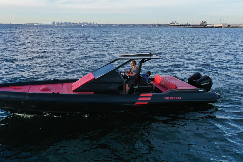Slide: The Image of 2023 Novielli Veloche 349 boat cruising on open water, featuring sleek design and vibrant red accents. - 17