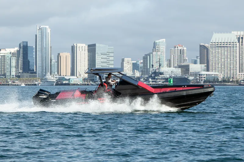 Slide: The Image of 2023 Novielli Veloche 349 speedboat cruising on water with city skyline backdrop. - 19