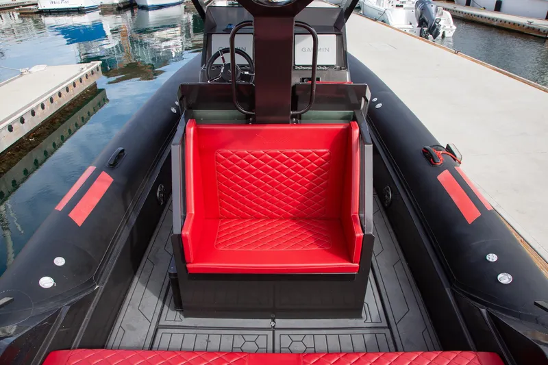 Slide: The Image of 2023 Novielli Veloche 349 boat with red quilted seating, docked at a marina. - 5
