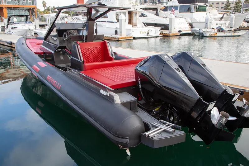 Slide: The Image of 2023 Novielli Veloche 349 boat with dual engines docked at a marina. - 6