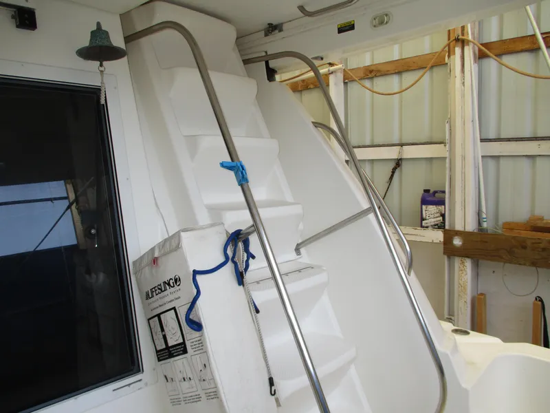 Slide: The Image of Staircase on 2000 Bayliner 5288 Pilot House yacht with metal railings and storage area. - 15