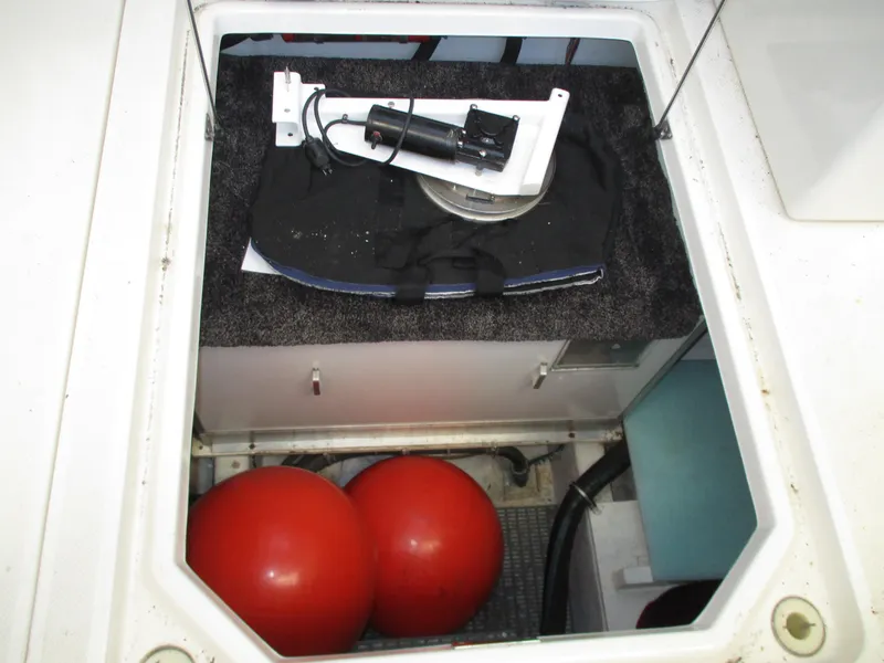 Slide: The Image of 2000 Bayliner 5288 Pilot House storage compartment with red buoys and equipment. - 19