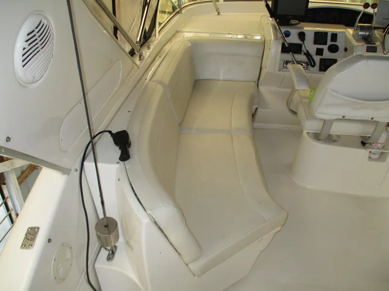 Slide: The Image of Interior of 2000 Bayliner 5288 Pilot House with white seating and control panel. - 28