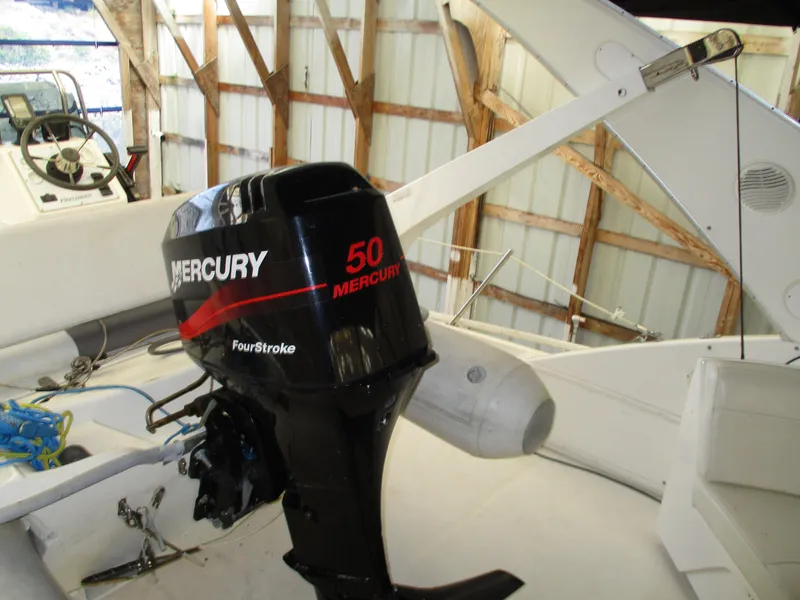 Slide: The Image of Bayliner 5288 Pilot House 2000 with Mercury 50 FourStroke outboard motor in a boathouse. - 30