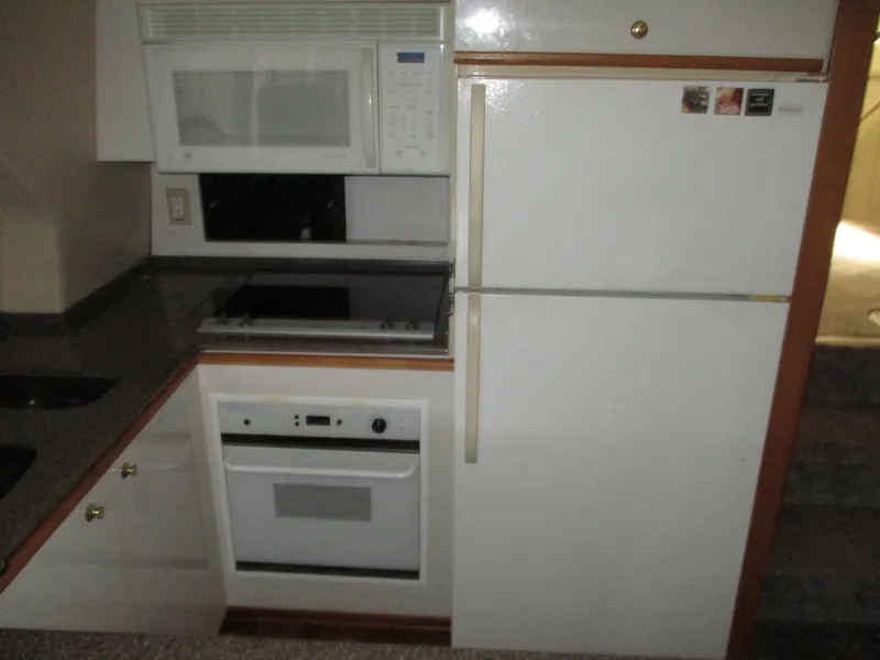 Slide: The Image of Kitchen appliances in a 2000 Bayliner 5288 Pilot House yacht, featuring a microwave and oven. - 42