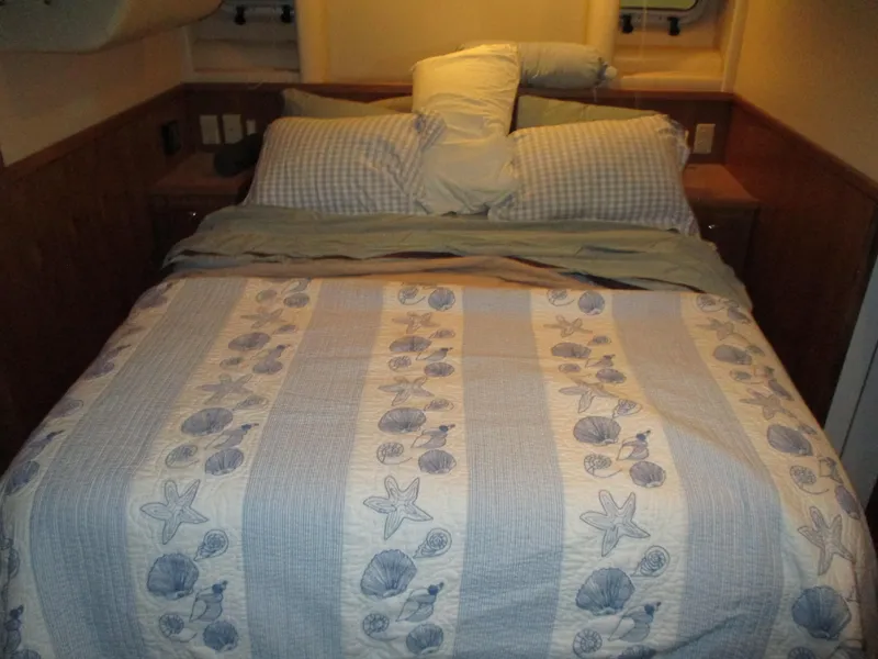 Slide: The Image of Cozy bedroom with nautical-themed bedding in a 2000 Bayliner 5288 Pilot House. - 44