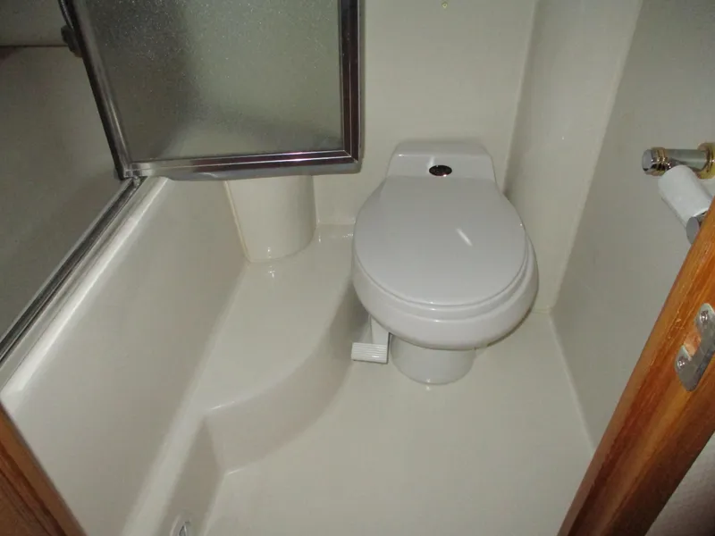Slide: The Image of Compact bathroom in 2000 Bayliner 5288 Pilot House yacht with toilet and shower. - 48