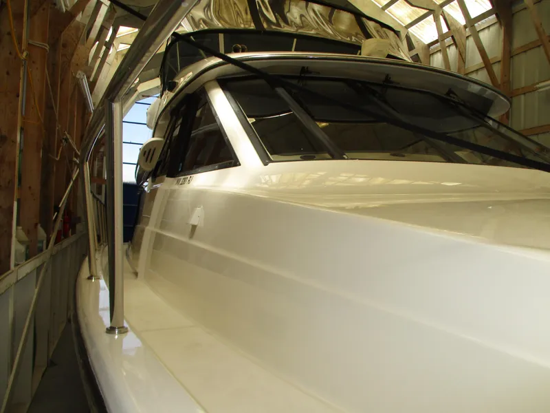 Slide: The Image of 2000 Bayliner 5288 Pilot House yacht in storage, showcasing sleek design and structure. - 8