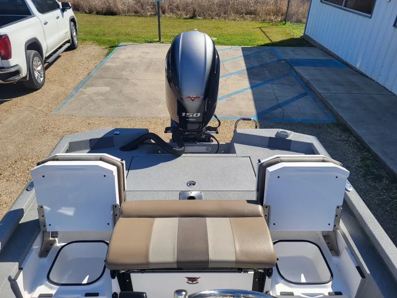 Slide: The Image of 2025 Vexus ACX 2000 boat with 150 HP engine, parked outdoors. - 10